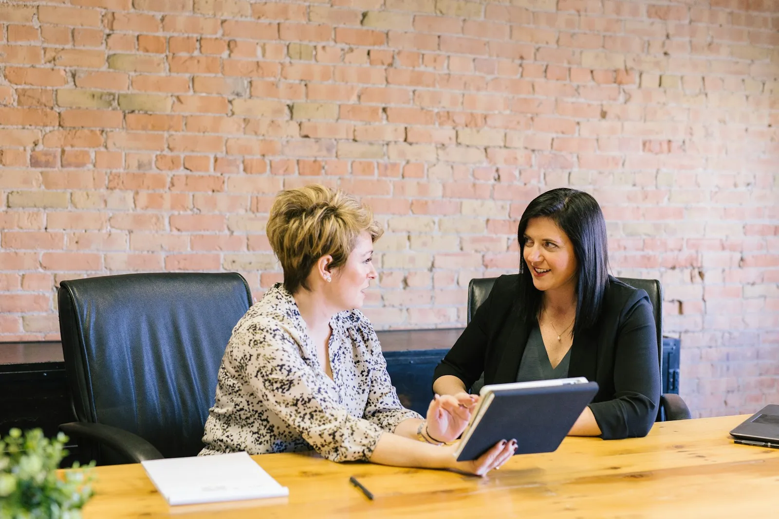 A business owner and an IT consultant reviewing a technology plan at a conference table