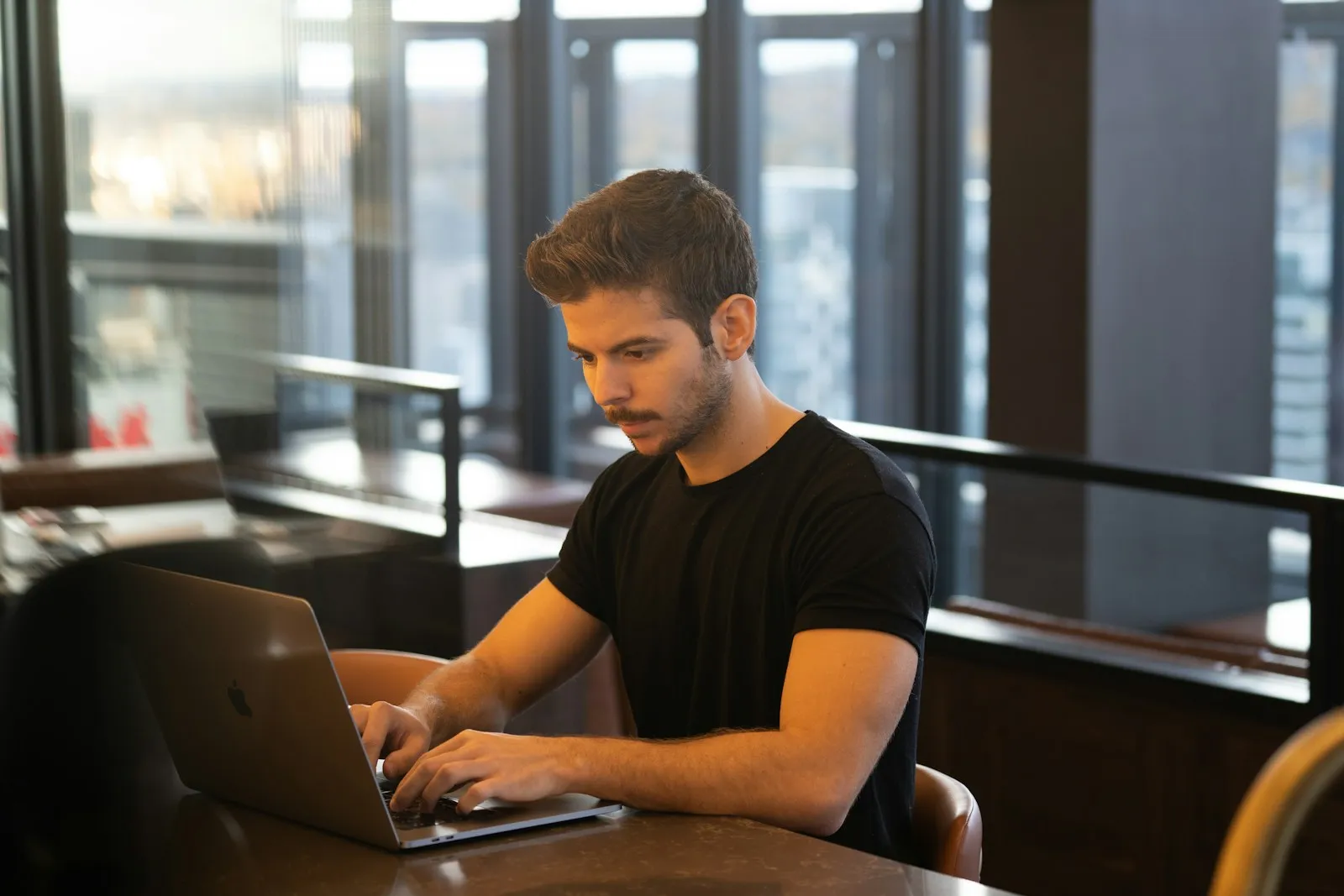 Man working on a laptop in a modern office