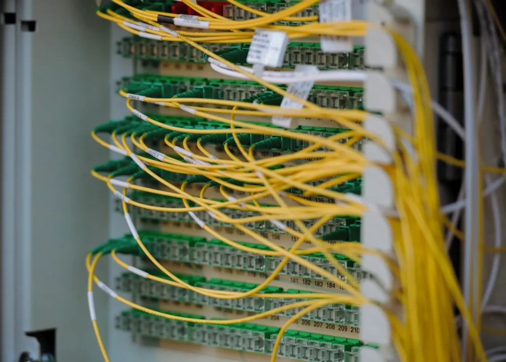 Fiber optic cables connected to network equipment in a server room