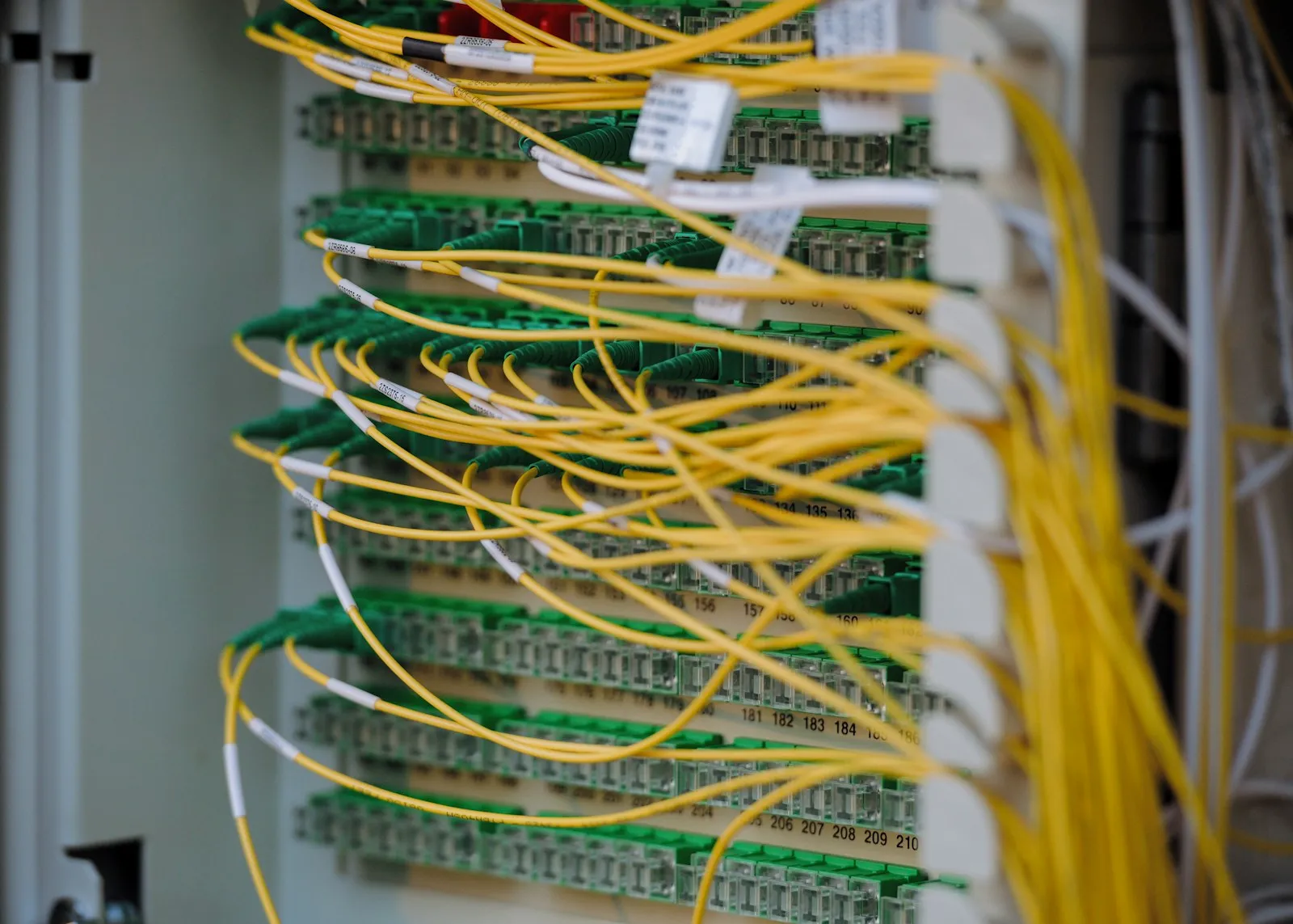 Fiber optic cables connected to network equipment in a server room