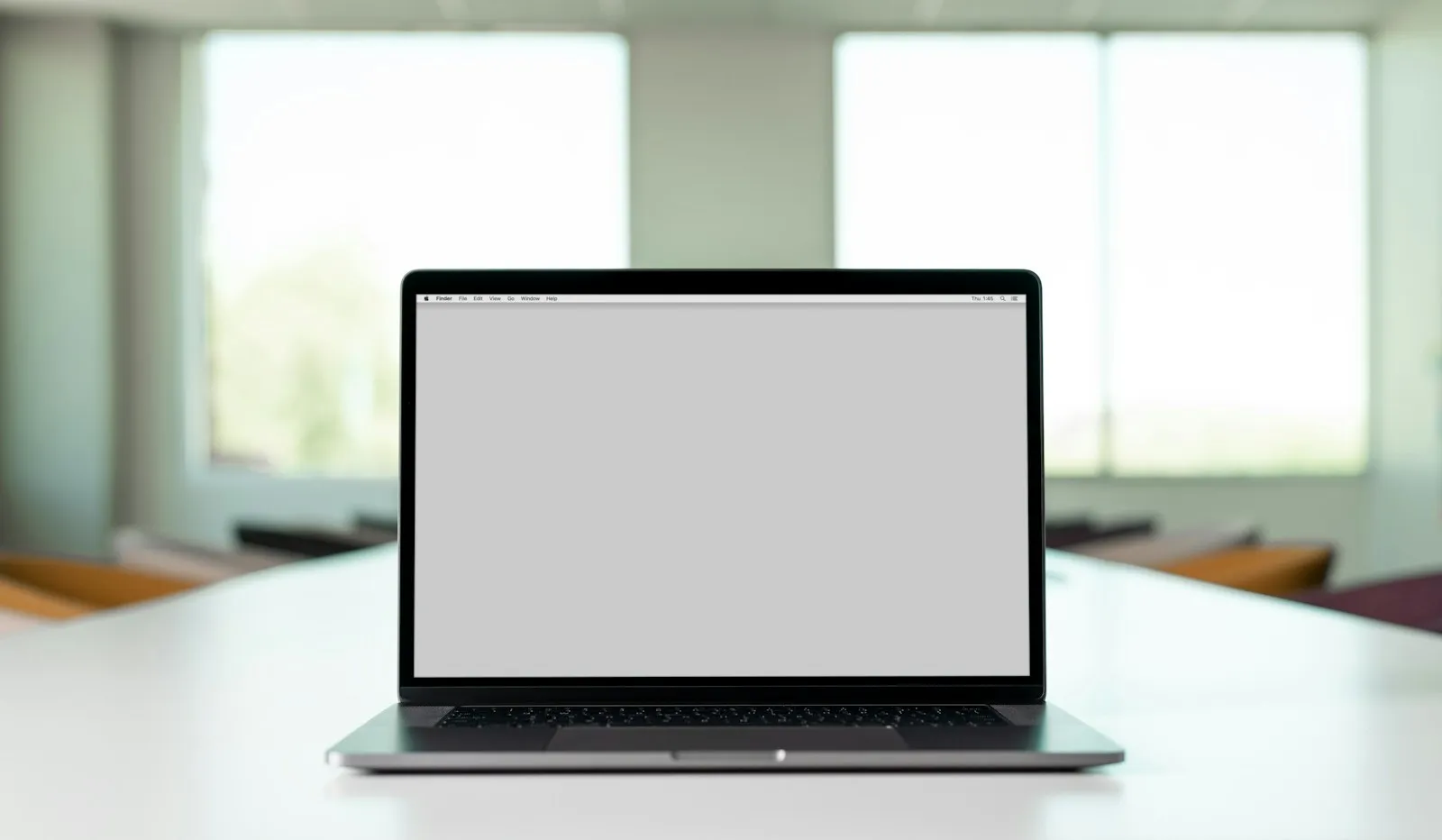 Laptop on a conference table in a bright office