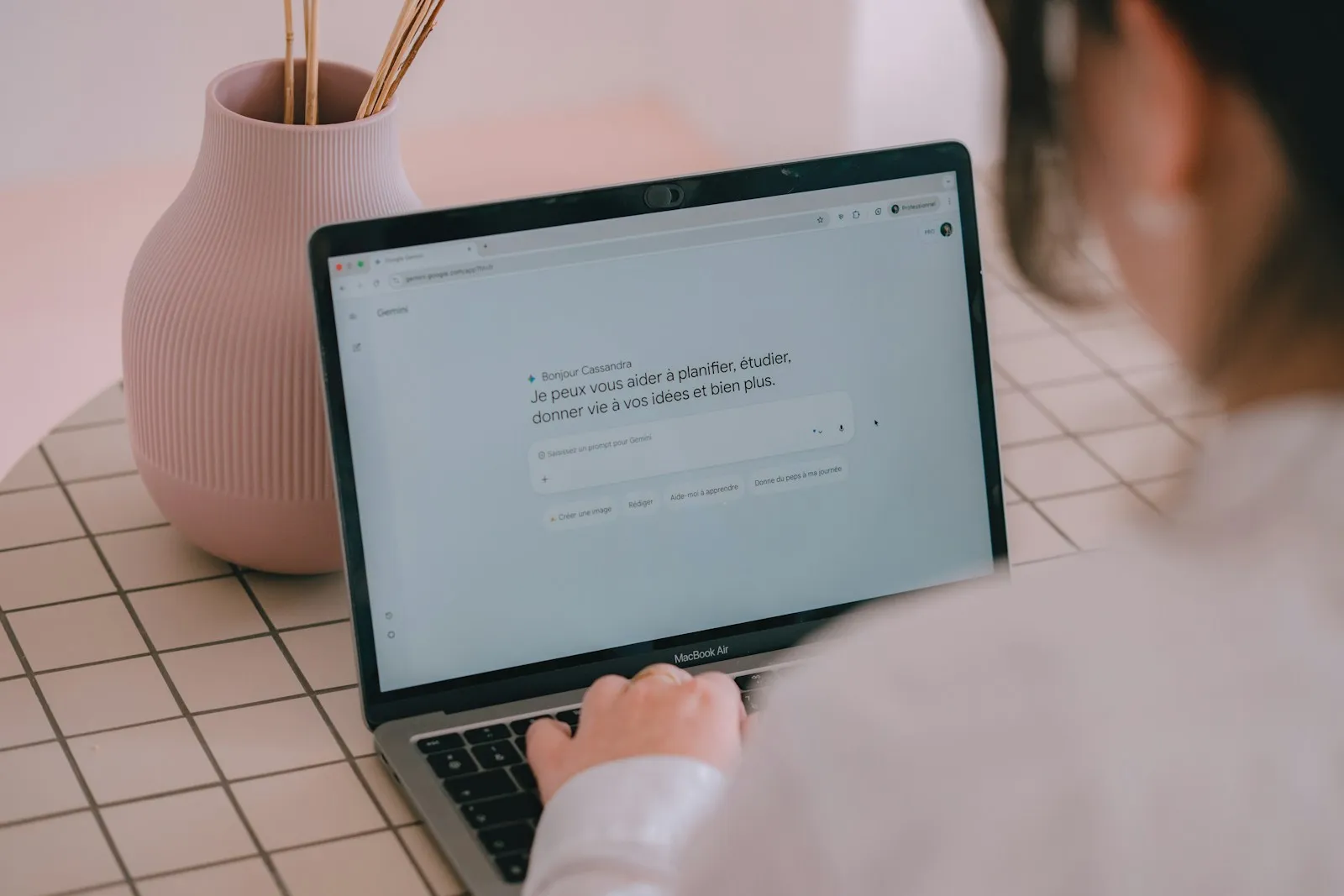 Person typing on a laptop with a blank prompt on the screen
