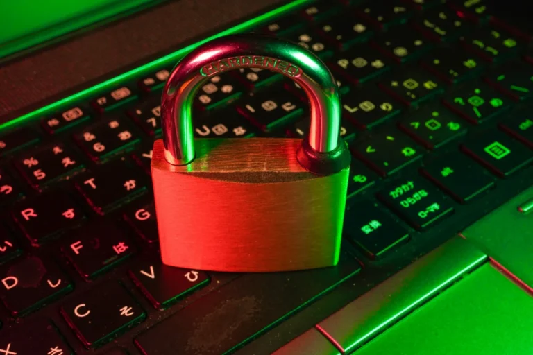 Laptop on an office desk showing a locked screen warning