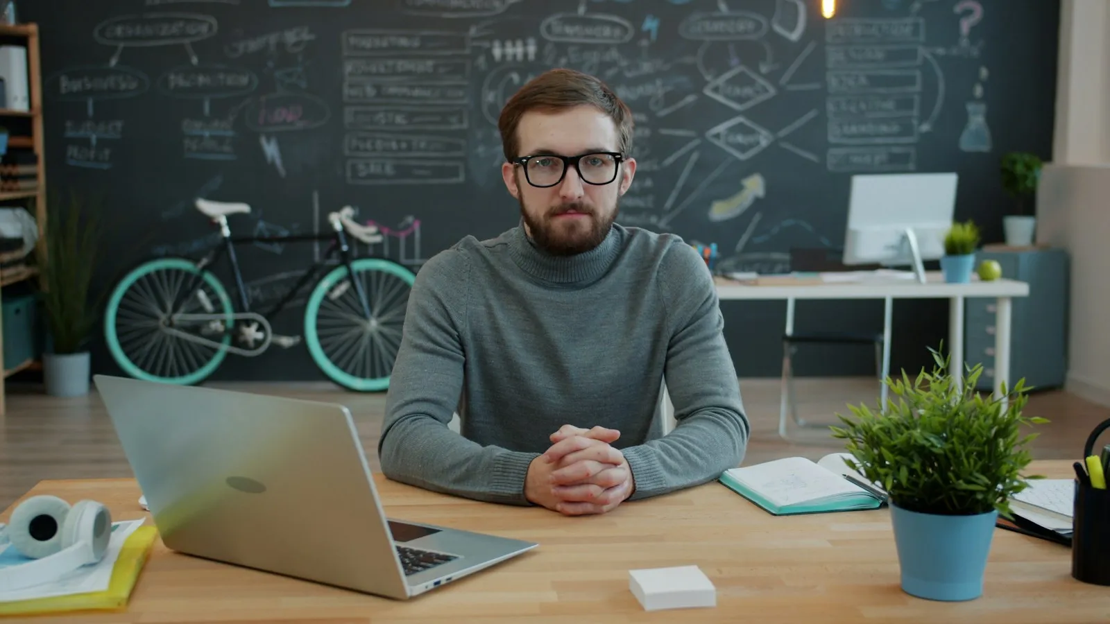 A small team in an office joining a video meeting on a laptop