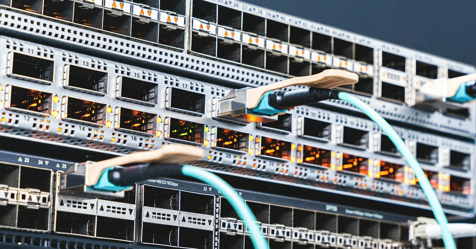 A neatly organized network rack with labeled patch cables and switches in an office network closet