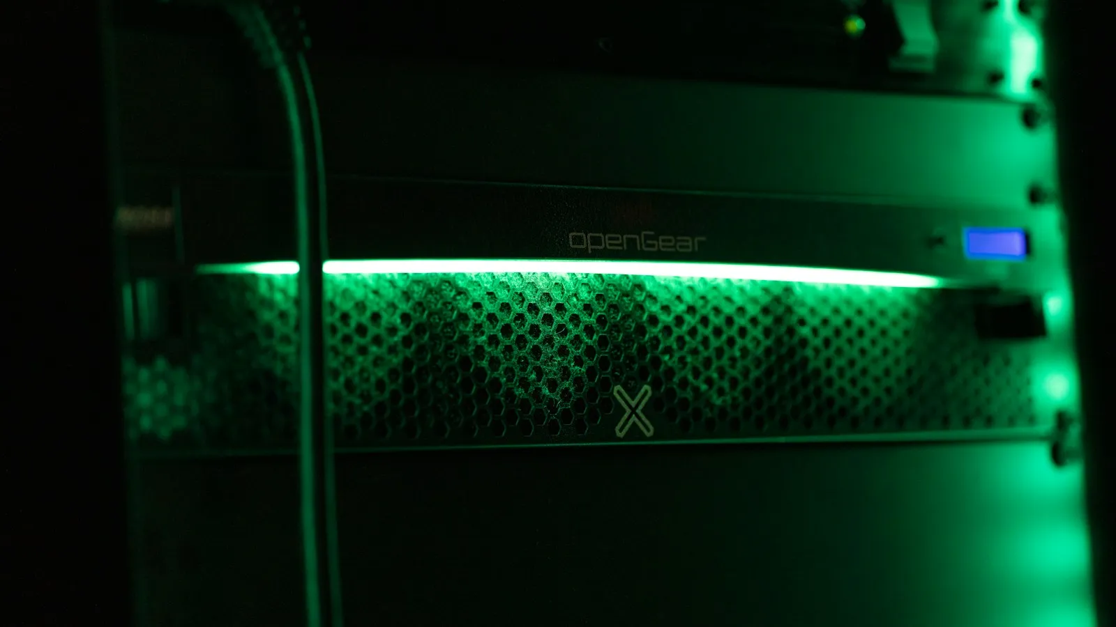 Server equipment glowing green in a dark room