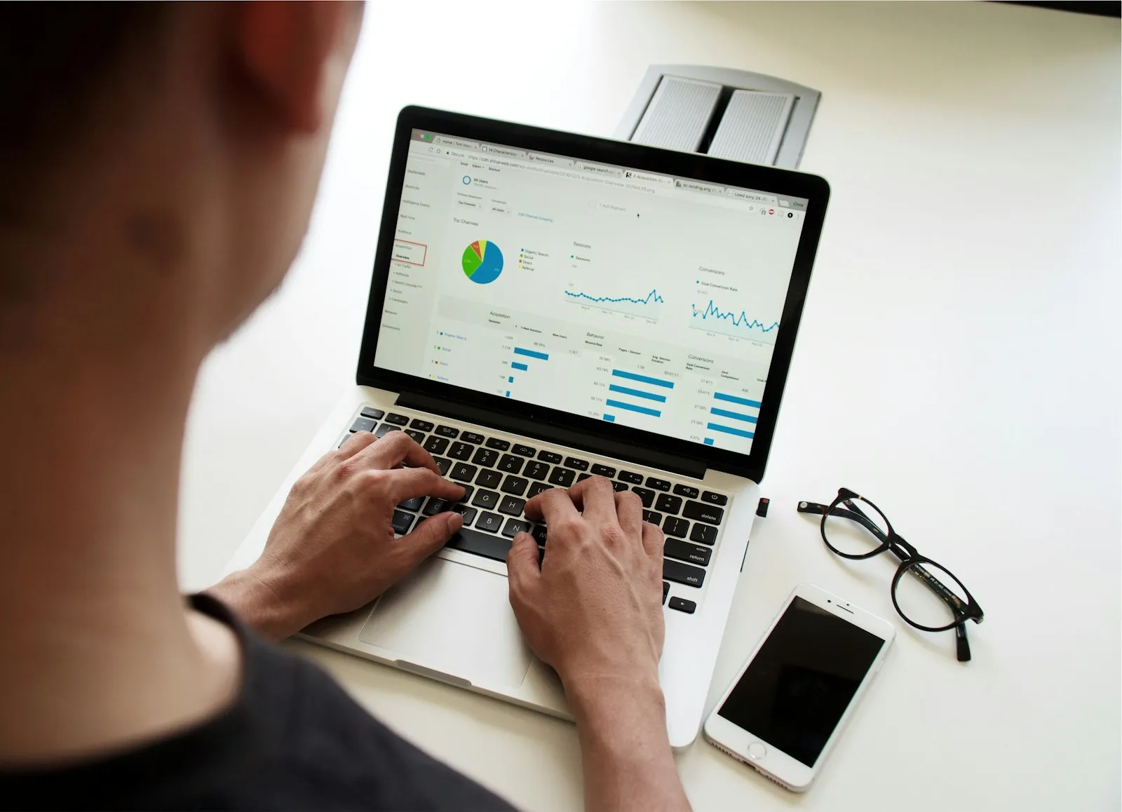 Person working on a laptop showing charts and reports
