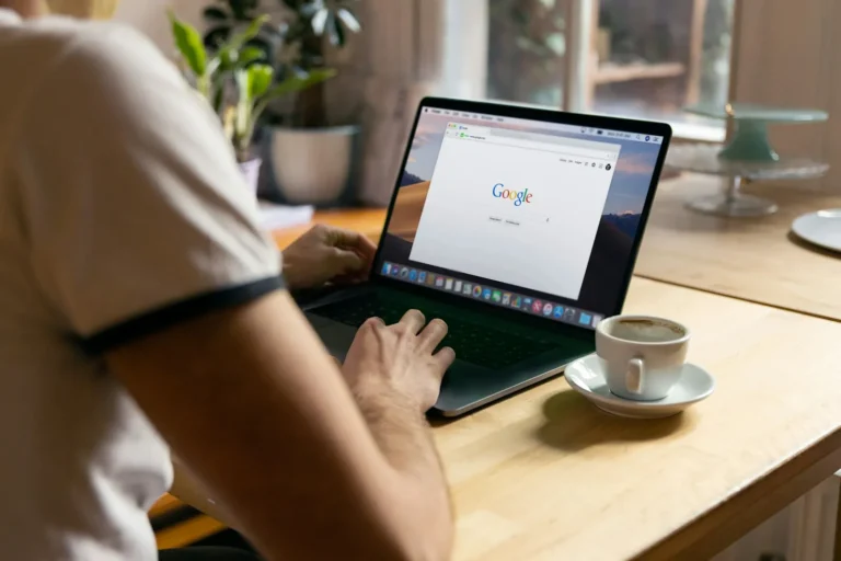 Close-up of a laptop screen showing a web browser in an office setting