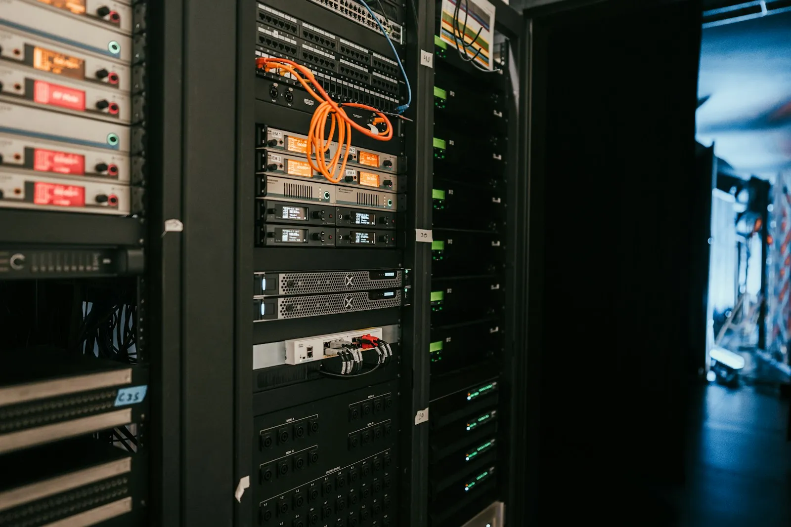 Rack-mounted battery backup unit below network switches in a small office server closet