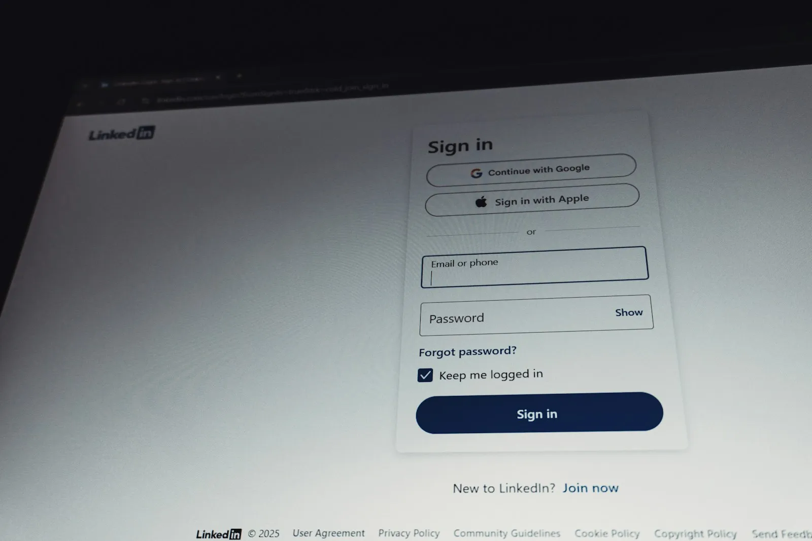 Close-up of a laptop showing a sign-in screen with a password field