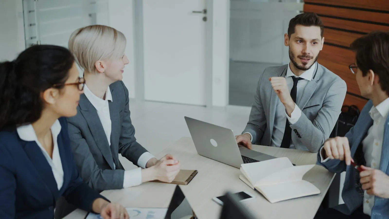 Small business owner and IT advisor reviewing a checklist at a desk with a laptop